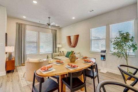 a dining room and living room with a table and chairs